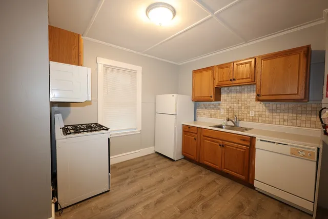 a kitchen with sink a stove and refrigerator