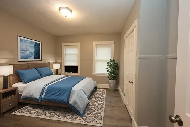 a bedroom with a large bed and a window