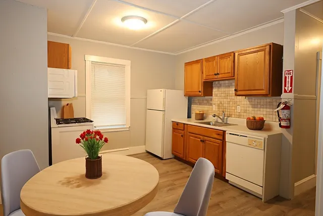 a kitchen with white cabinets and stainless steel appliances