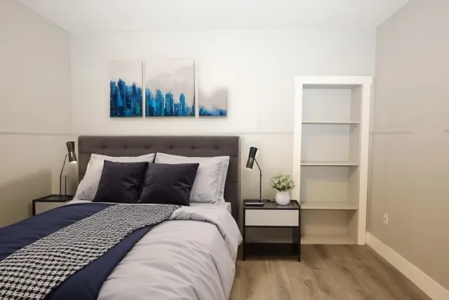 a bedroom with a bed and night stand