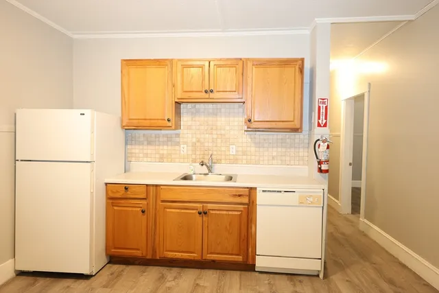 a utility room with cabinets washer and dryer