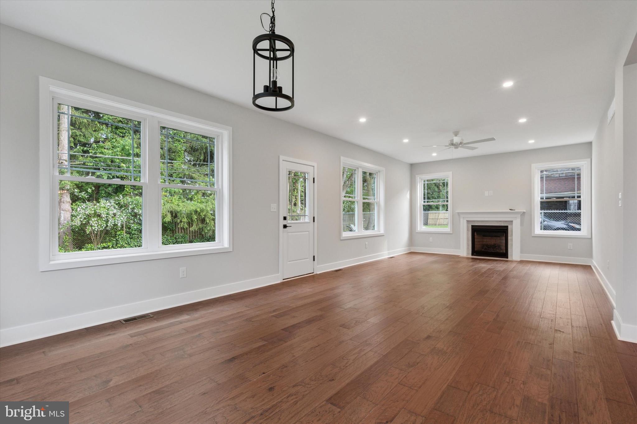 721 Walden Road Cheltenham, PA 19012 - Photo 11 of 25 a view of empty room with wooden floor and fireplace