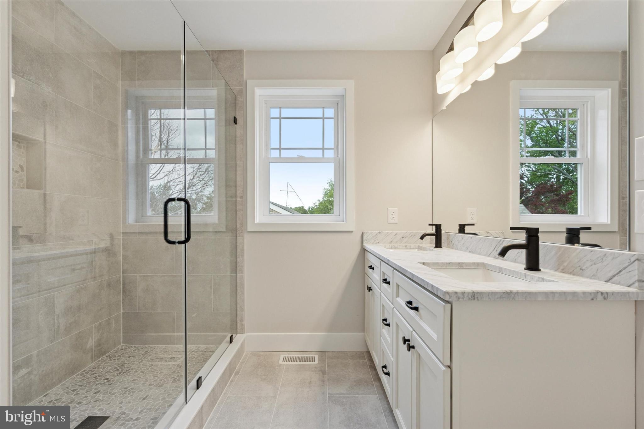 721 Walden Road Cheltenham, PA 19012 - Photo 18 of 25 a bathroom with a shower sink and mirror