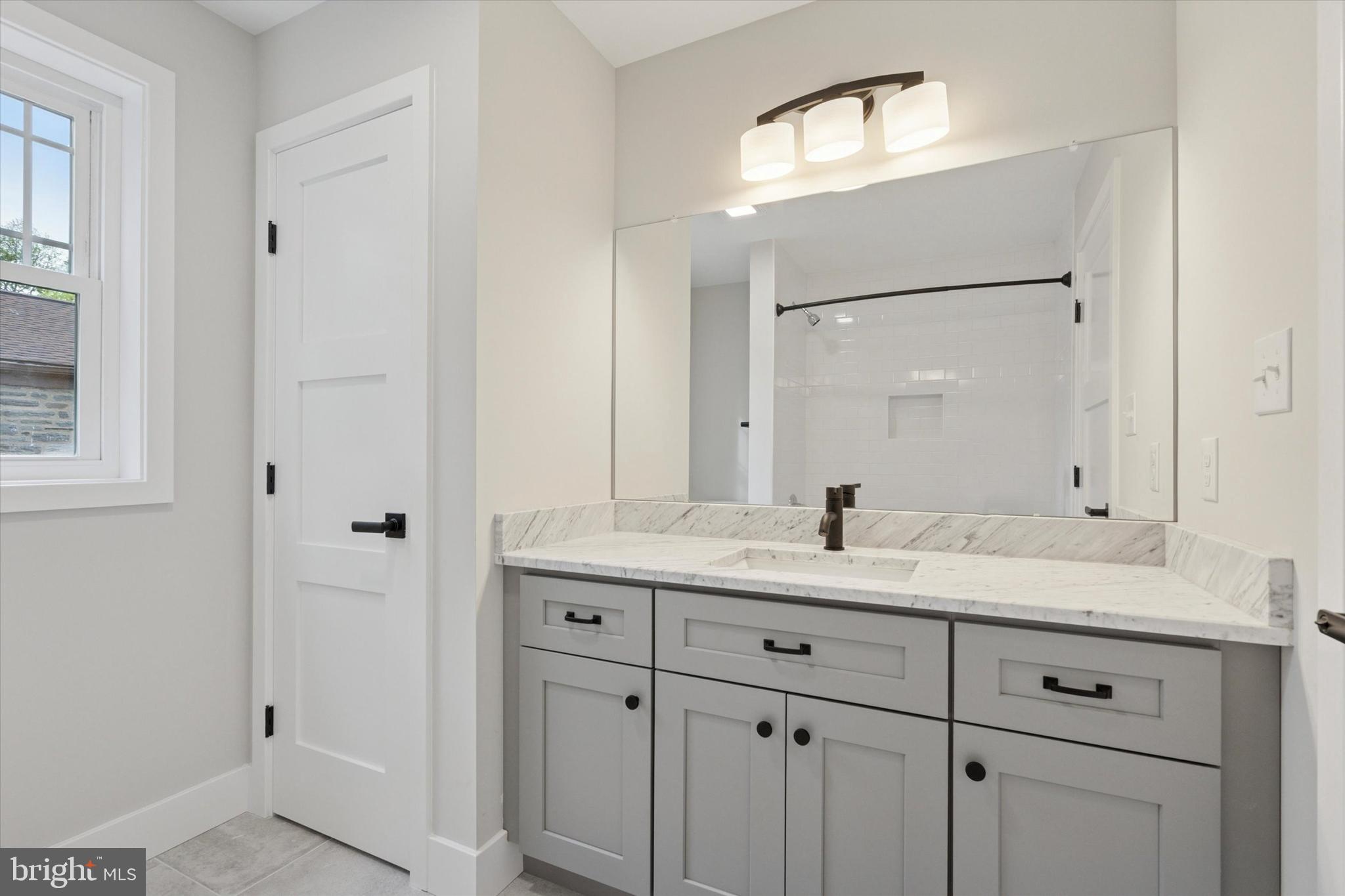 721 Walden Road Cheltenham, PA 19012 - Photo 20 of 25 a bathroom with a granite countertop sink and a mirror