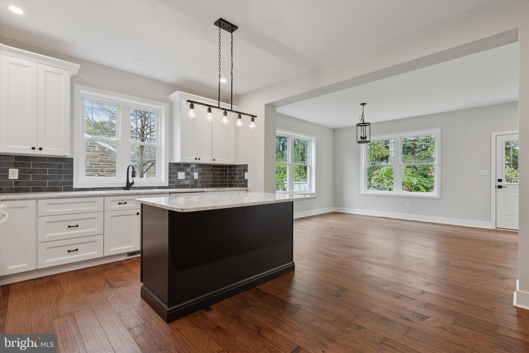 721 Walden Road Cheltenham, PA 19012 - Photo 5 of 25 a kitchen with stainless steel appliances granite countertop a stove a sink and white cabinets with wooden floors