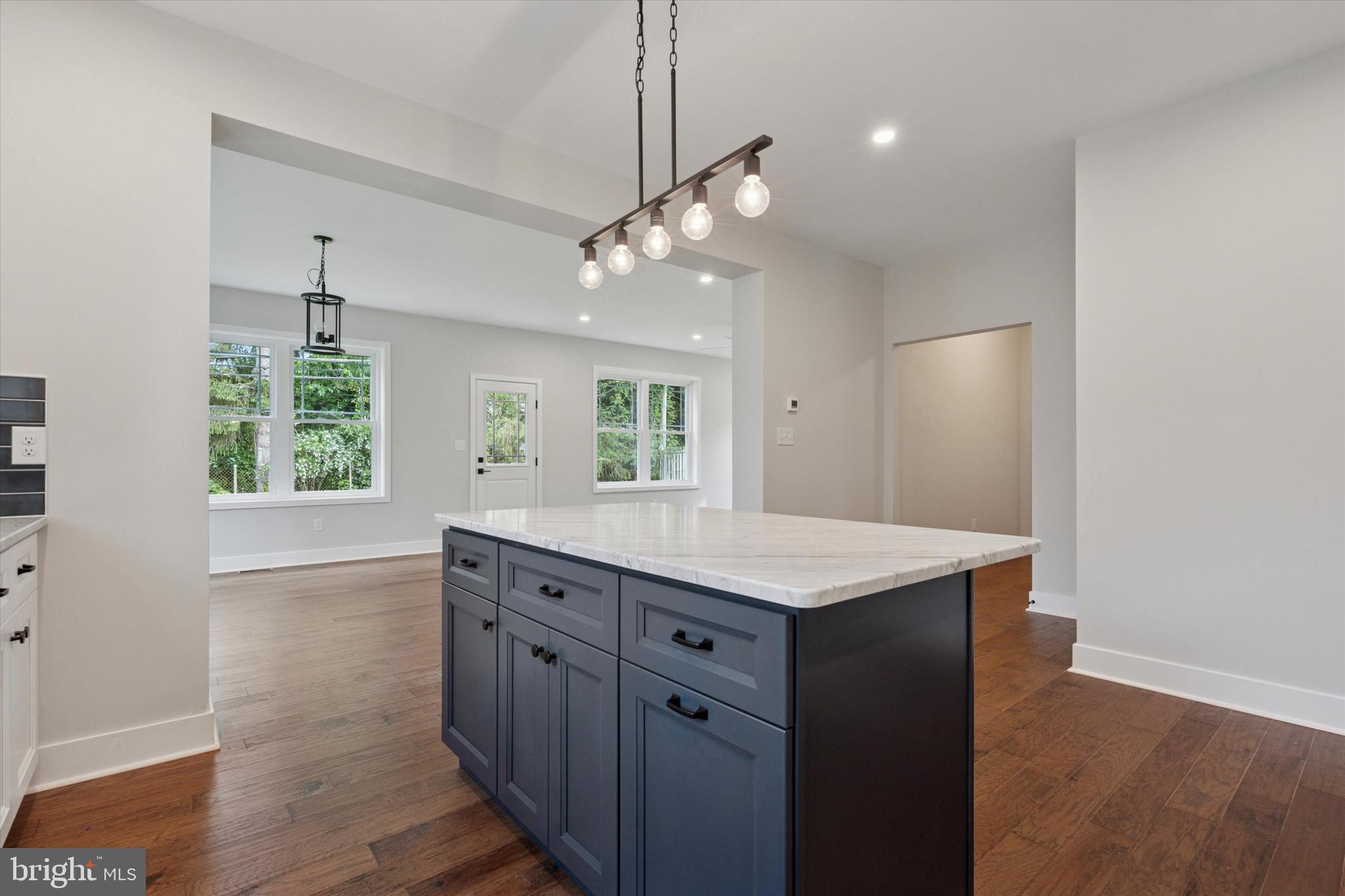 721 Walden Road Cheltenham, PA 19012 - Photo 6 of 25 a kitchen with a wooden floor and a ceiling fan