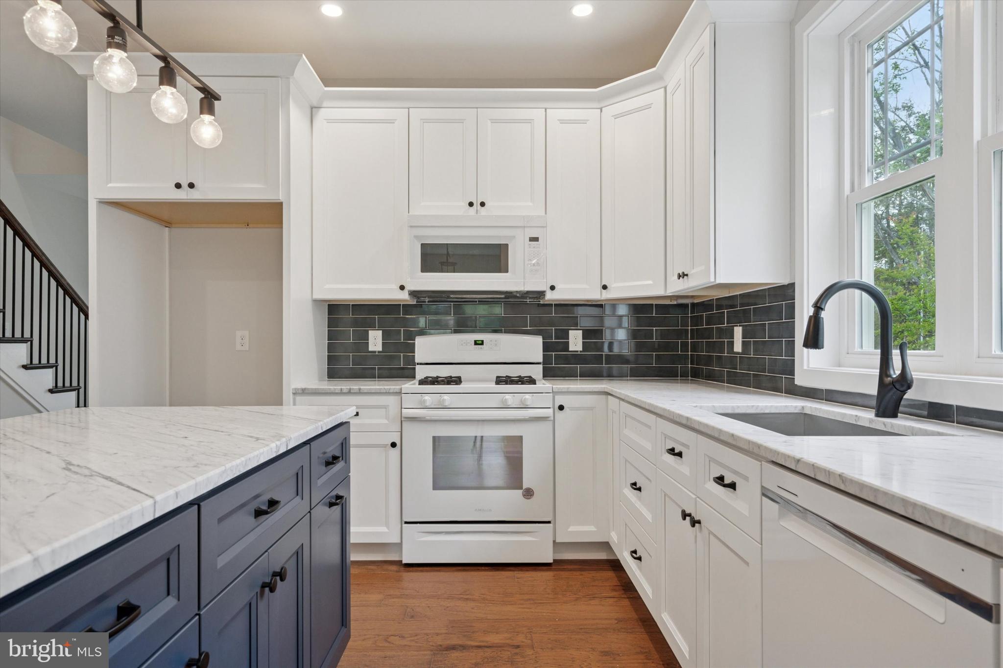 721 Walden Road Cheltenham, PA 19012 - Photo 7 of 25 a kitchen with cabinets appliances a sink and a window