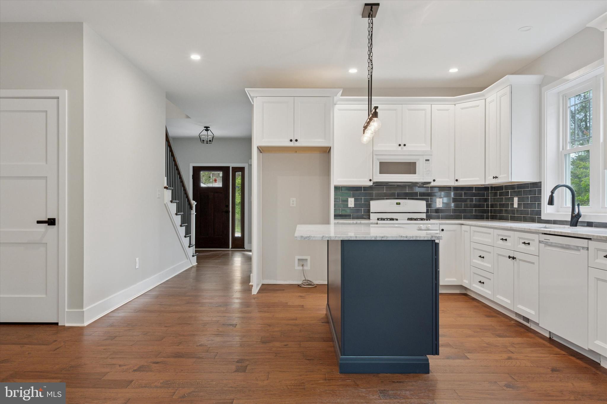 721 Walden Road Cheltenham, PA 19012 - Photo 9 of 25 a kitchen with kitchen island white cabinets and refrigerator