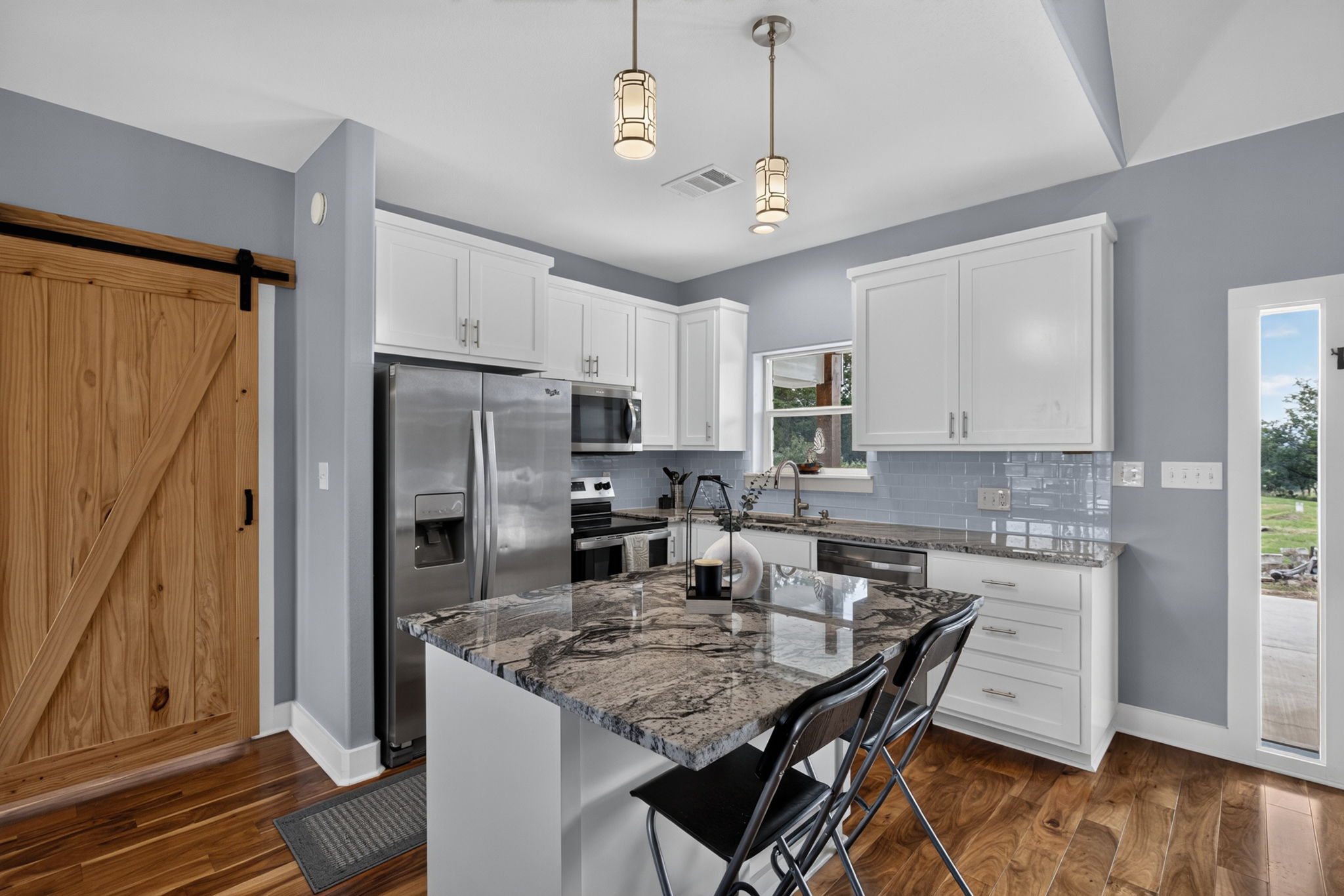 207 Deer Ridge Drive Burnet, TX 78611 - Photo 18 of 36 Granite counters and stainless steel appliances elevate this beautifully appointed kitchen.