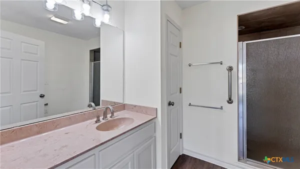 a bathroom with a granite countertop sink and a mirror