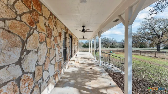 a view of a livingroom with a fireplace a chandelier and wooden floor