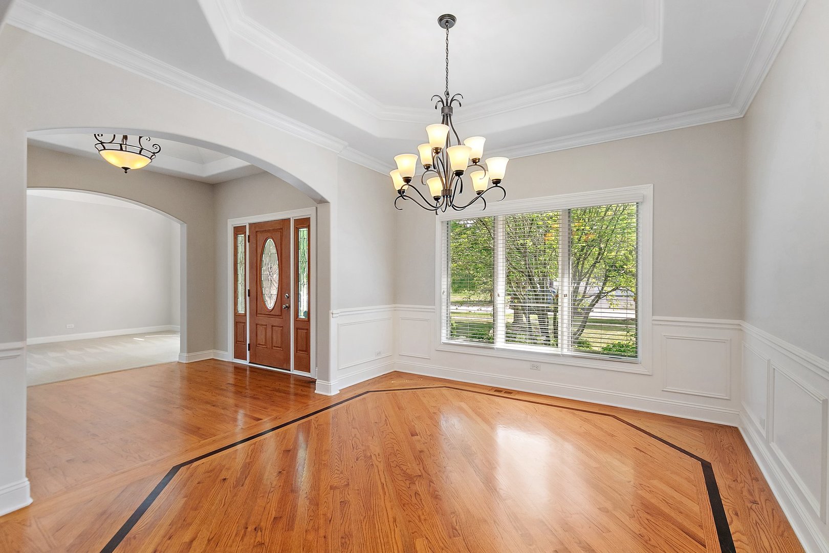2073 Westover Road North Aurora, IL 60542 - Photo 3 of 24 a view of an empty room with a window and wooden floor