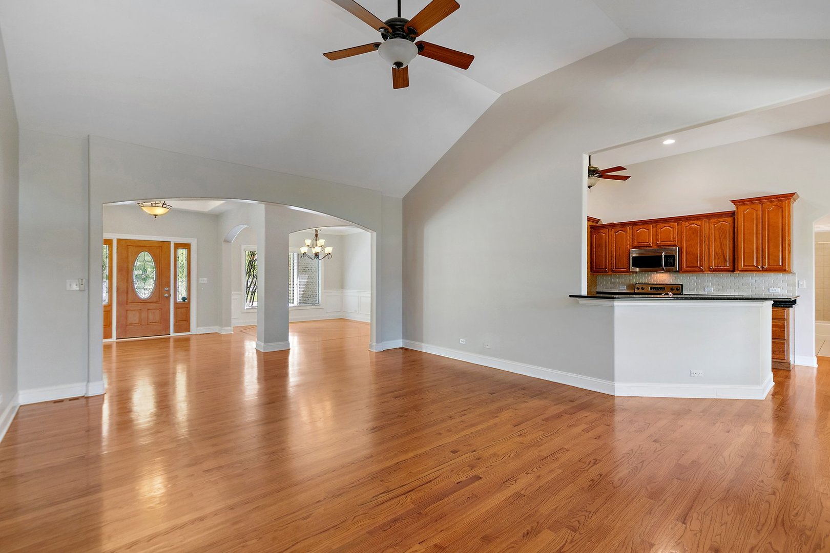 2073 Westover Road North Aurora, IL 60542 - Photo 7 of 24 a view of a room with wooden floor and a ceiling fan