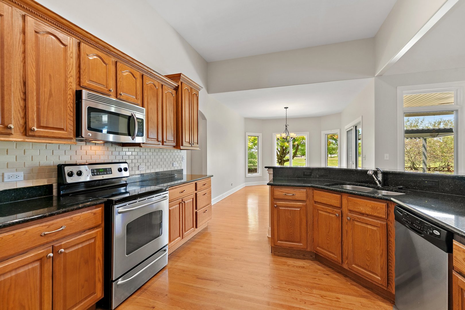 2073 Westover Road North Aurora, IL 60542 - Photo 9 of 24 a kitchen with stainless steel appliances granite countertop wooden cabinets stove top oven and sink