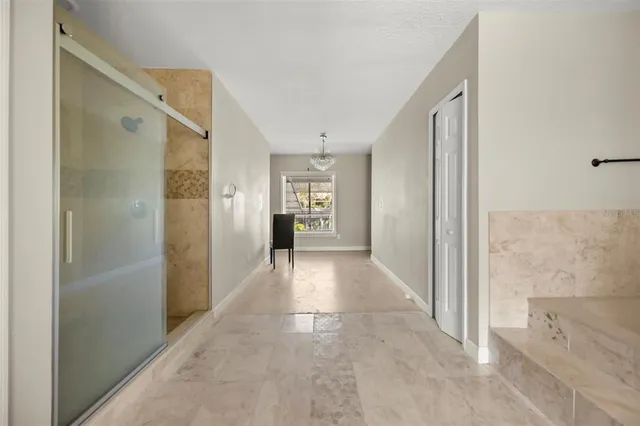 a view of a hallway with wooden shelves