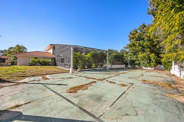 a view of a house with basketball court