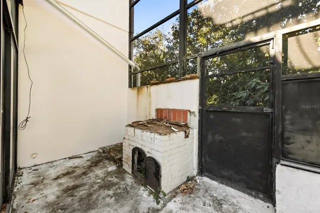 a utility room with a washing machine and a fireplace