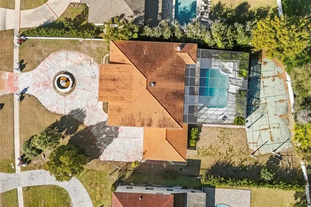 an aerial view of a house with a yard