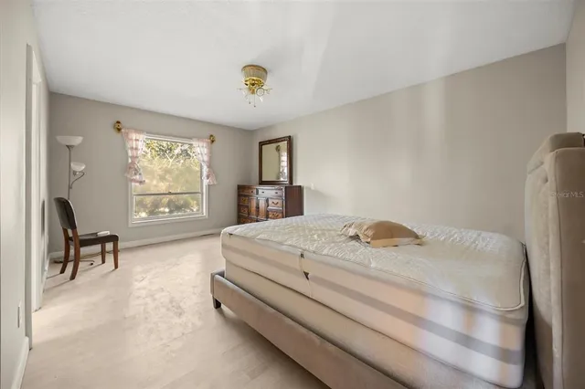 a bedroom with a bed and a table in it