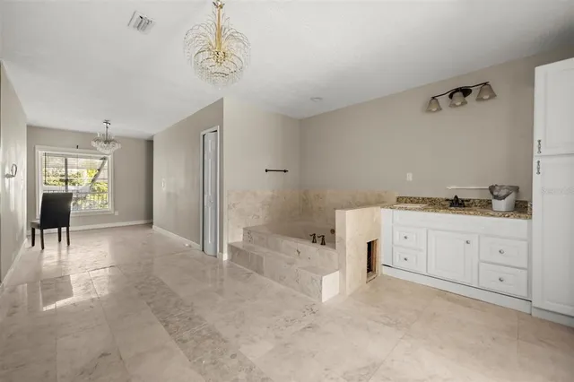 a spacious bathroom with a granite countertop sink a toilet and shower