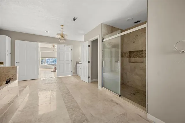 a view of a bathroom with a shower and a sink