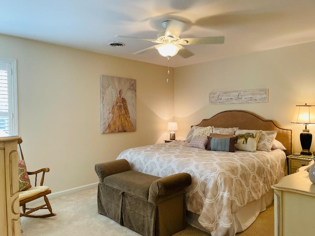 106 Mindy Circle Collierville, TN 38017 - Photo 17 of 25 a bedroom with a bed and a chandelier