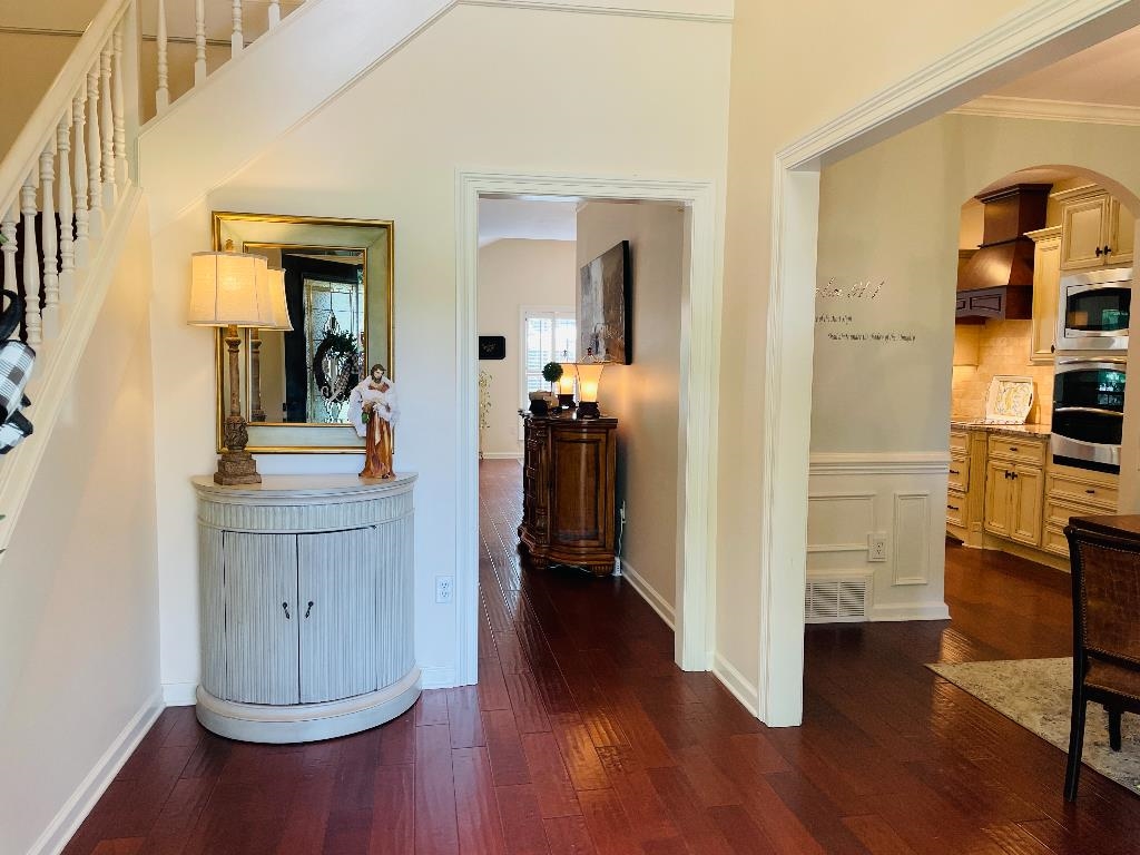 106 Mindy Circle Collierville, TN 38017 - Photo 4 of 25 a view of a hallway with wooden floor and furniture