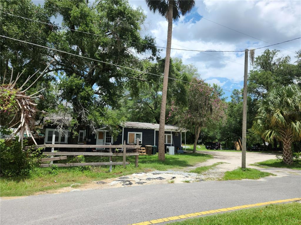 1007 Northeast 25th Street Ocala, FL 34470 - Photo 1 of 9 a front view of a house with a yard