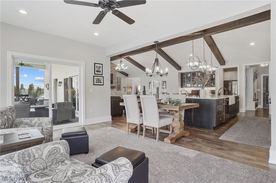 4437 Beach Road Medina, OH 44256 - Photo 17 of 50 Living room featuring dark hardwood / wood-style flooring, vaulted ceiling with beams, and ceiling fan with notable chandelier