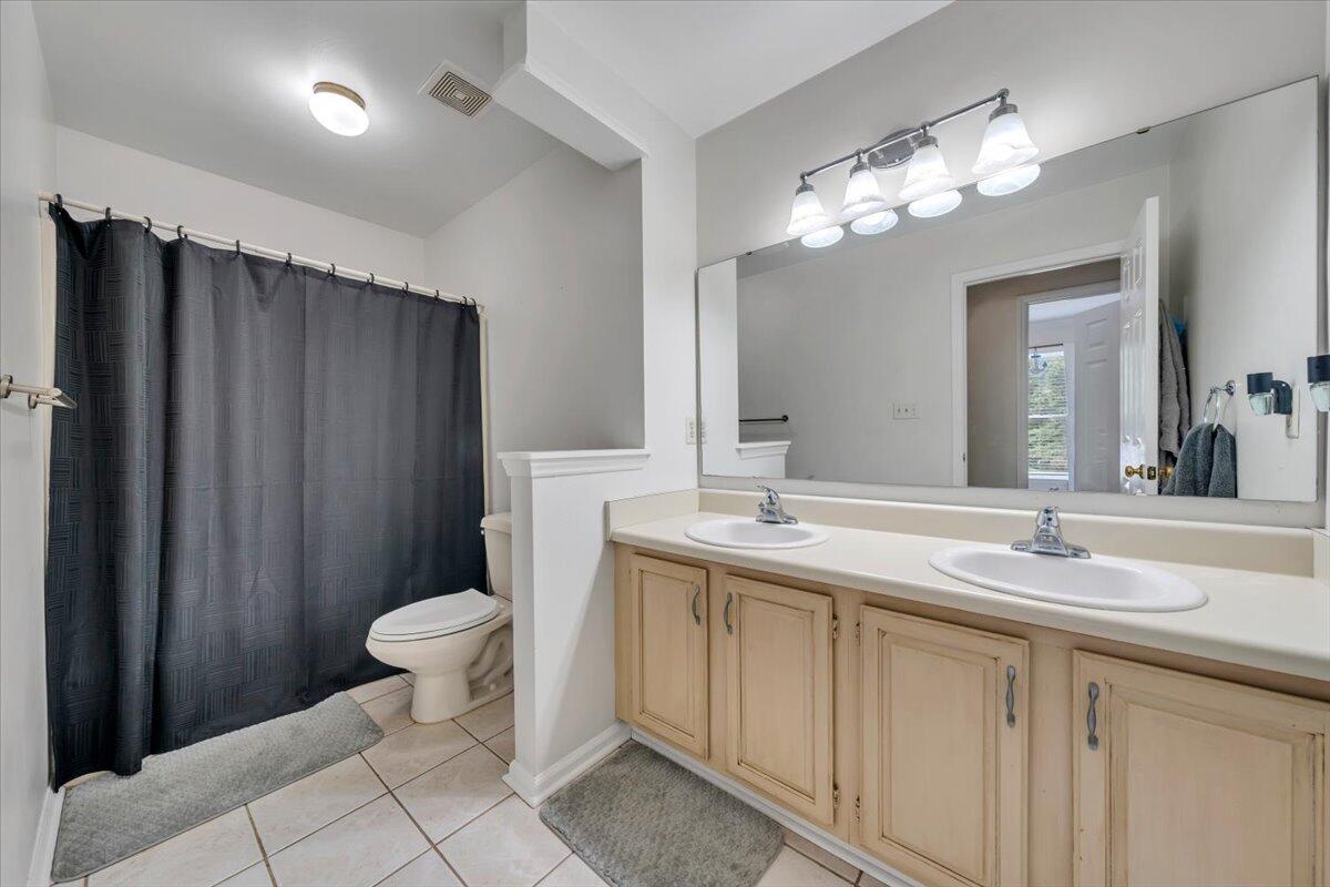 7851 Cedar Edge Road Roanoke, VA 24018 - Photo 21 of 44 a bathroom with a sink toilet a mirror a vanity and shower view