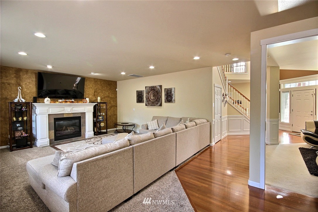 12946 Southeast 216th Place Kent, WA 98031 - Photo 12 of 39 a living room with furniture a fireplace and a flat screen tv