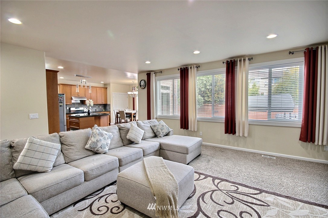 12946 Southeast 216th Place Kent, WA 98031 - Photo 13 of 39 a living room with furniture and large windows