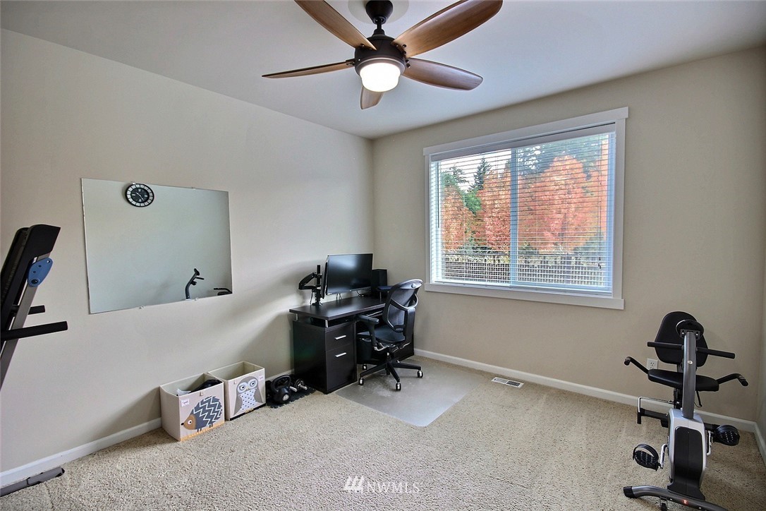 12946 Southeast 216th Place Kent, WA 98031 - Photo 16 of 39 a room with gym equipment and a window