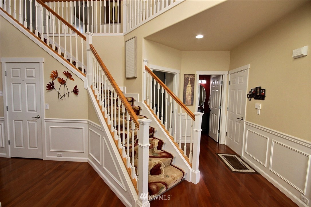 12946 Southeast 216th Place Kent, WA 98031 - Photo 17 of 39 a view of staircase with lots of frames on wall and wooden floor