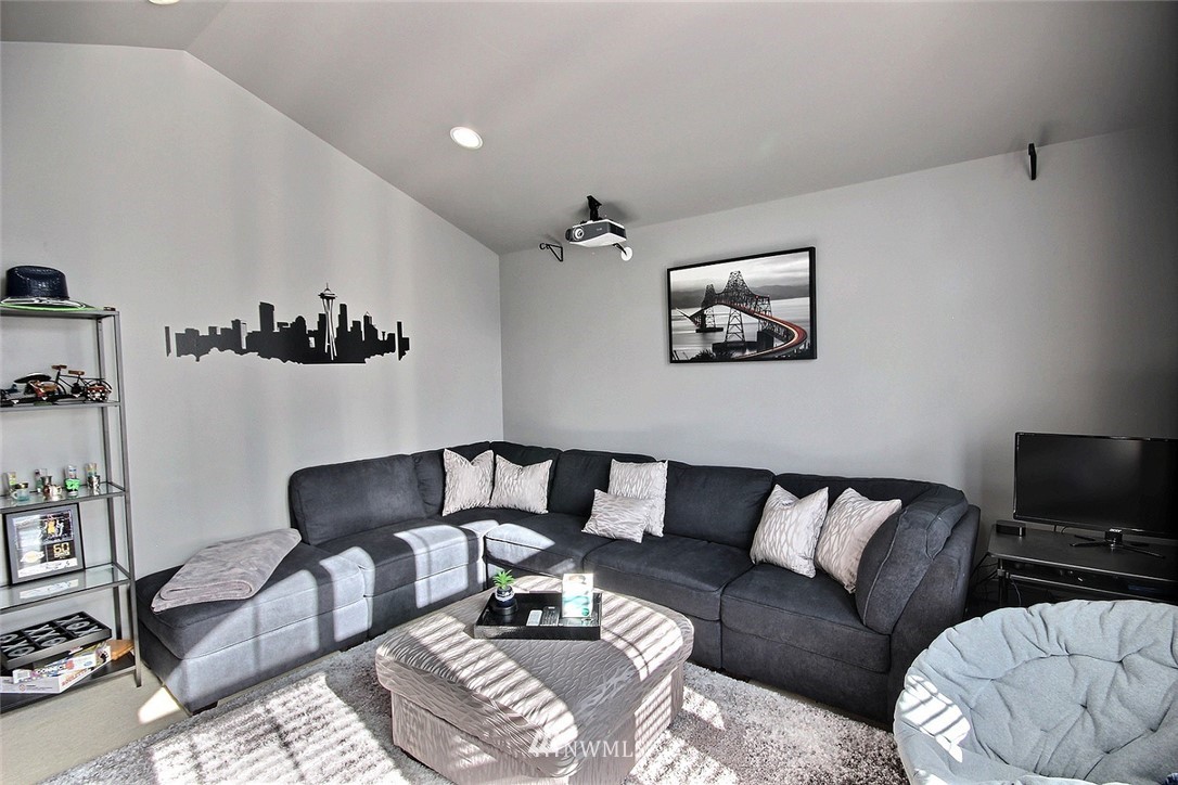 12946 Southeast 216th Place Kent, WA 98031 - Photo 19 of 39 a living room with furniture a couch and a flat screen tv