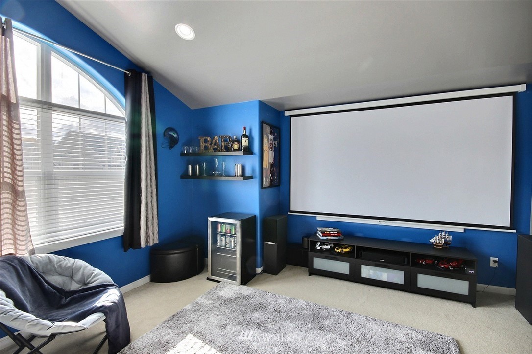 12946 Southeast 216th Place Kent, WA 98031 - Photo 20 of 39 a living room with furniture gym equipment and a large window