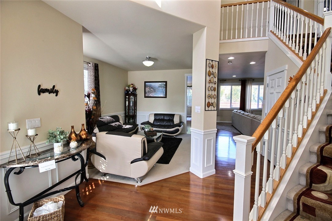 12946 Southeast 216th Place Kent, WA 98031 - Photo 3 of 39 a living room with furniture and a chandelier