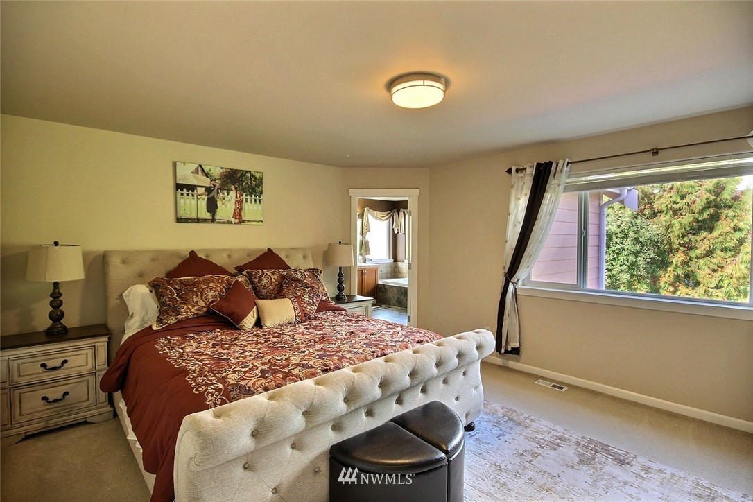 12946 Southeast 216th Place Kent, WA 98031 - Photo 21 of 39 a large bed sitting in a bedroom next to a window