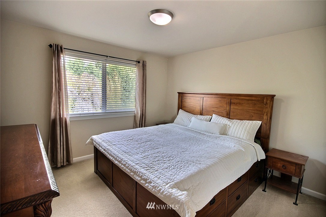 12946 Southeast 216th Place Kent, WA 98031 - Photo 26 of 39 a bed sitting in a bedroom next to a window