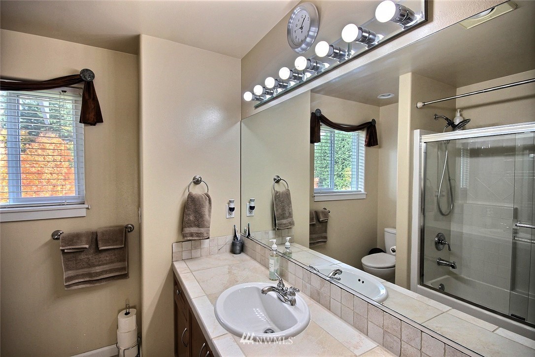 12946 Southeast 216th Place Kent, WA 98031 - Photo 27 of 39 a bathroom with a sink double vanity and a mirror