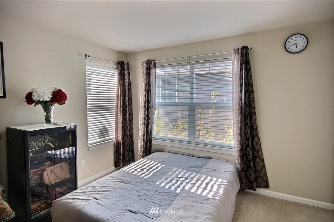12946 Southeast 216th Place Kent, WA 98031 - Photo 28 of 39 a bedroom with a bed and a window