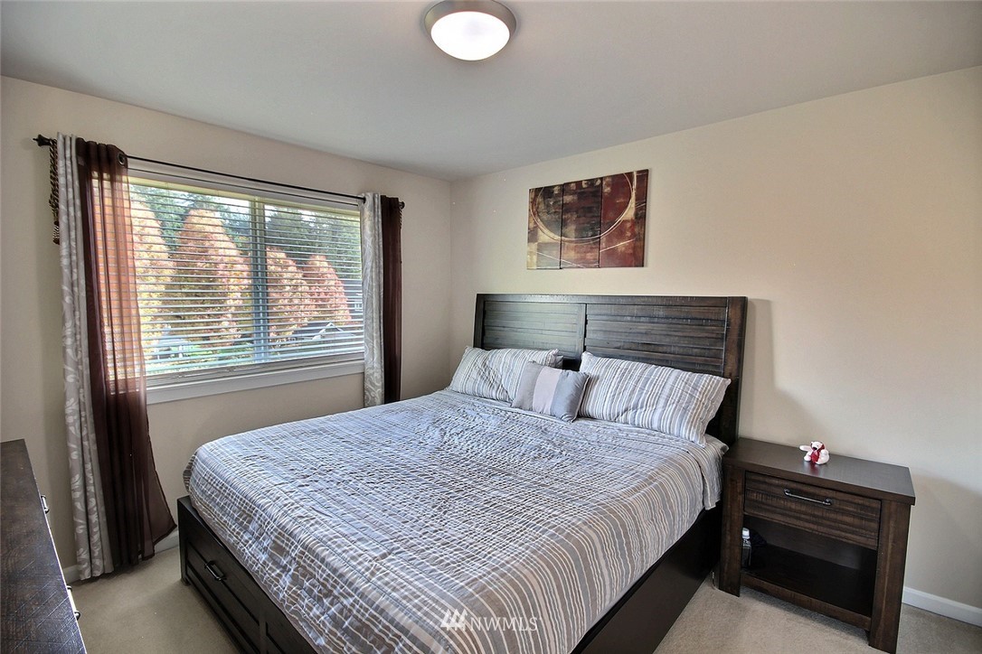 12946 Southeast 216th Place Kent, WA 98031 - Photo 29 of 39 a bedroom with a bed and a window