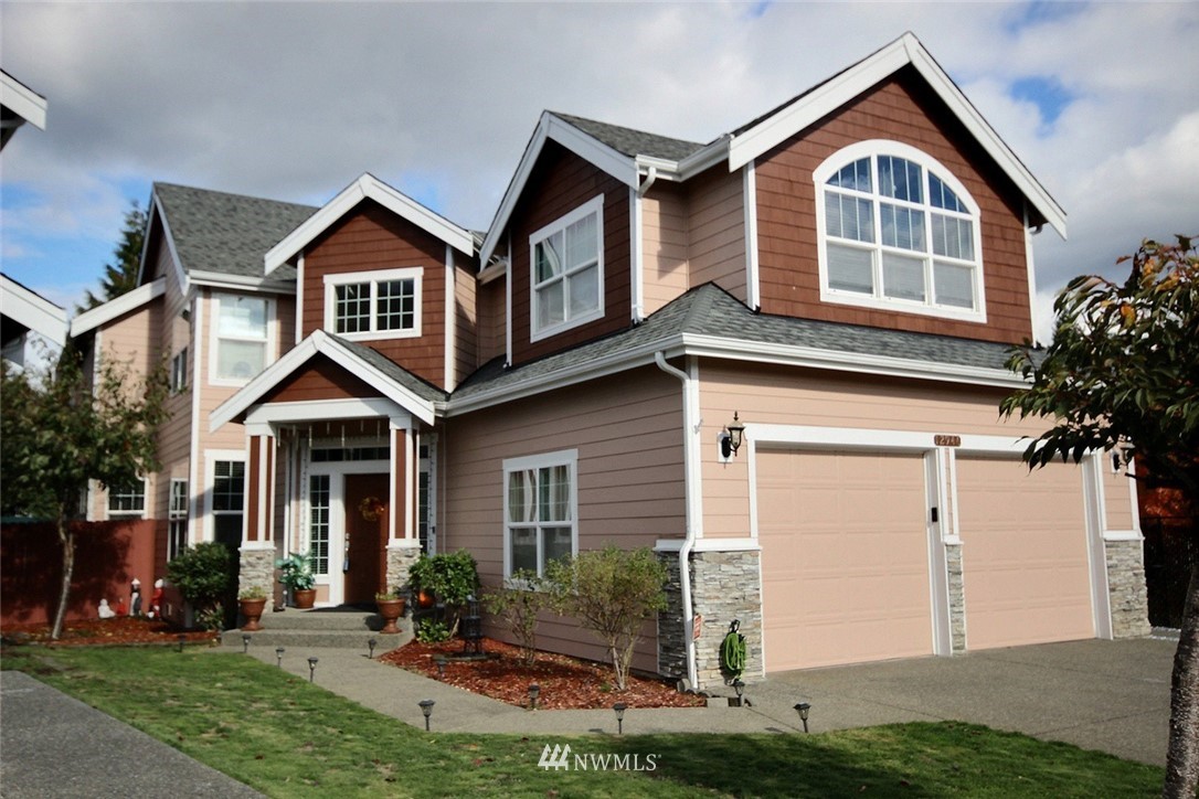 12946 Southeast 216th Place Kent, WA 98031 - Photo 33 of 39 a front view of a house with a yard and garage