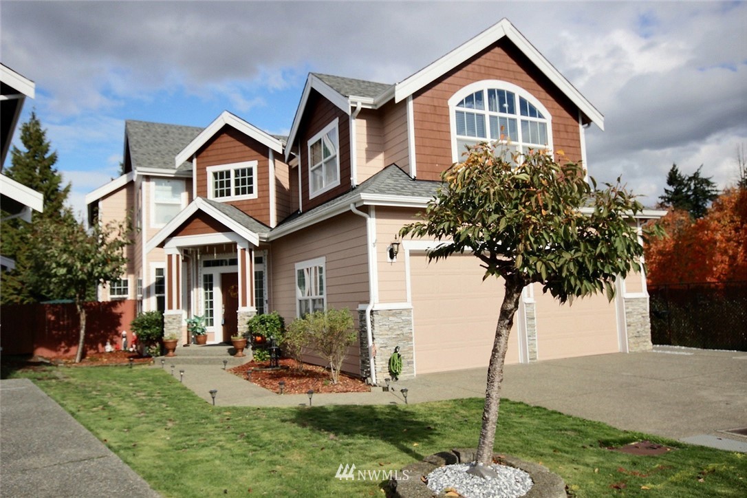 12946 Southeast 216th Place Kent, WA 98031 - Photo 34 of 39 a front view of a house with yard and green space