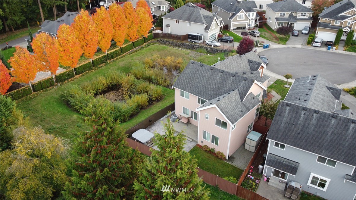 12946 Southeast 216th Place Kent, WA 98031 - Photo 36 of 39 an aerial view of a house with a garden and lake view