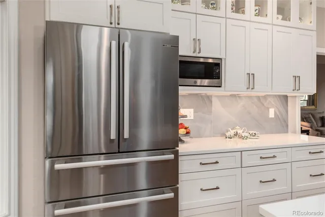 a close view of a cabinets and stainless steel appliances