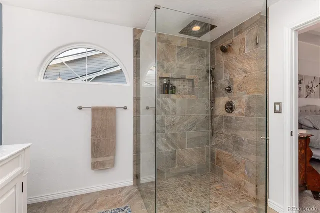 a bathroom with a glass shower door and a sink