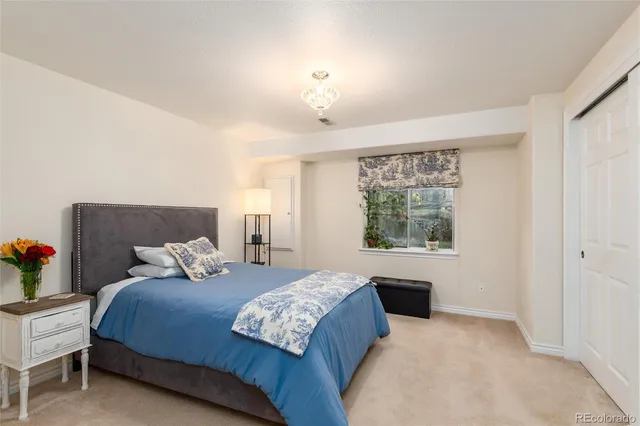 a bedroom with a large bed and a window