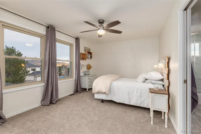 a bedroom with a bed couch and window