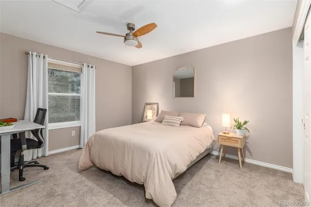 a bedroom with a bed a desk and chair